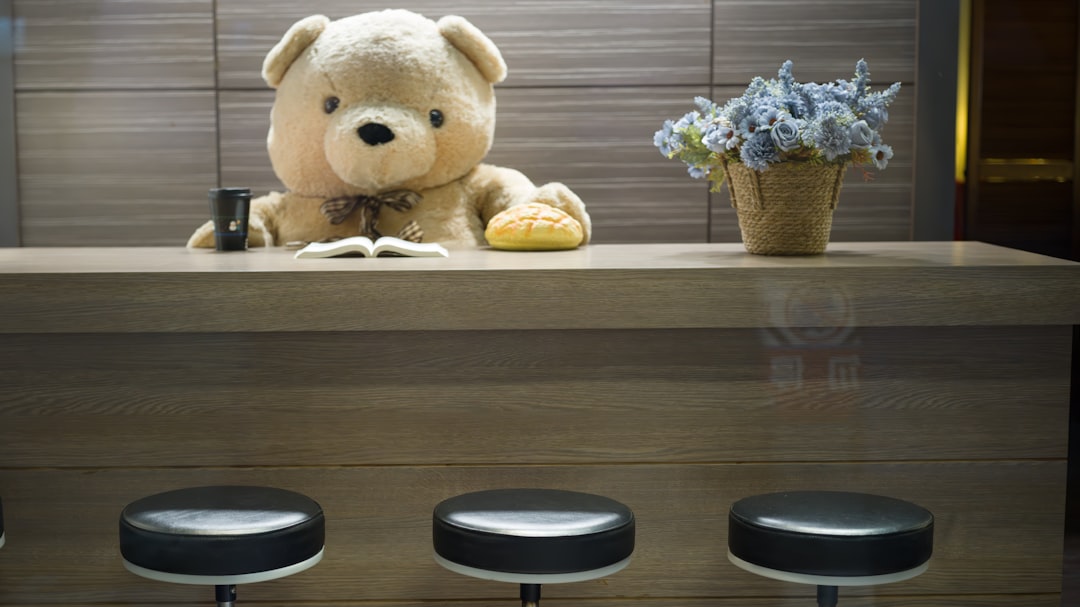 Cozy teddy bear with a book and flowers